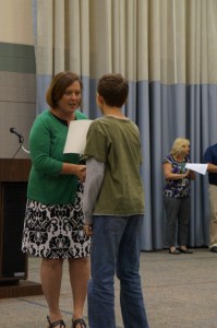 Model Principal Lynne Peters congratulates a student at the fifth-grade graduation last week.